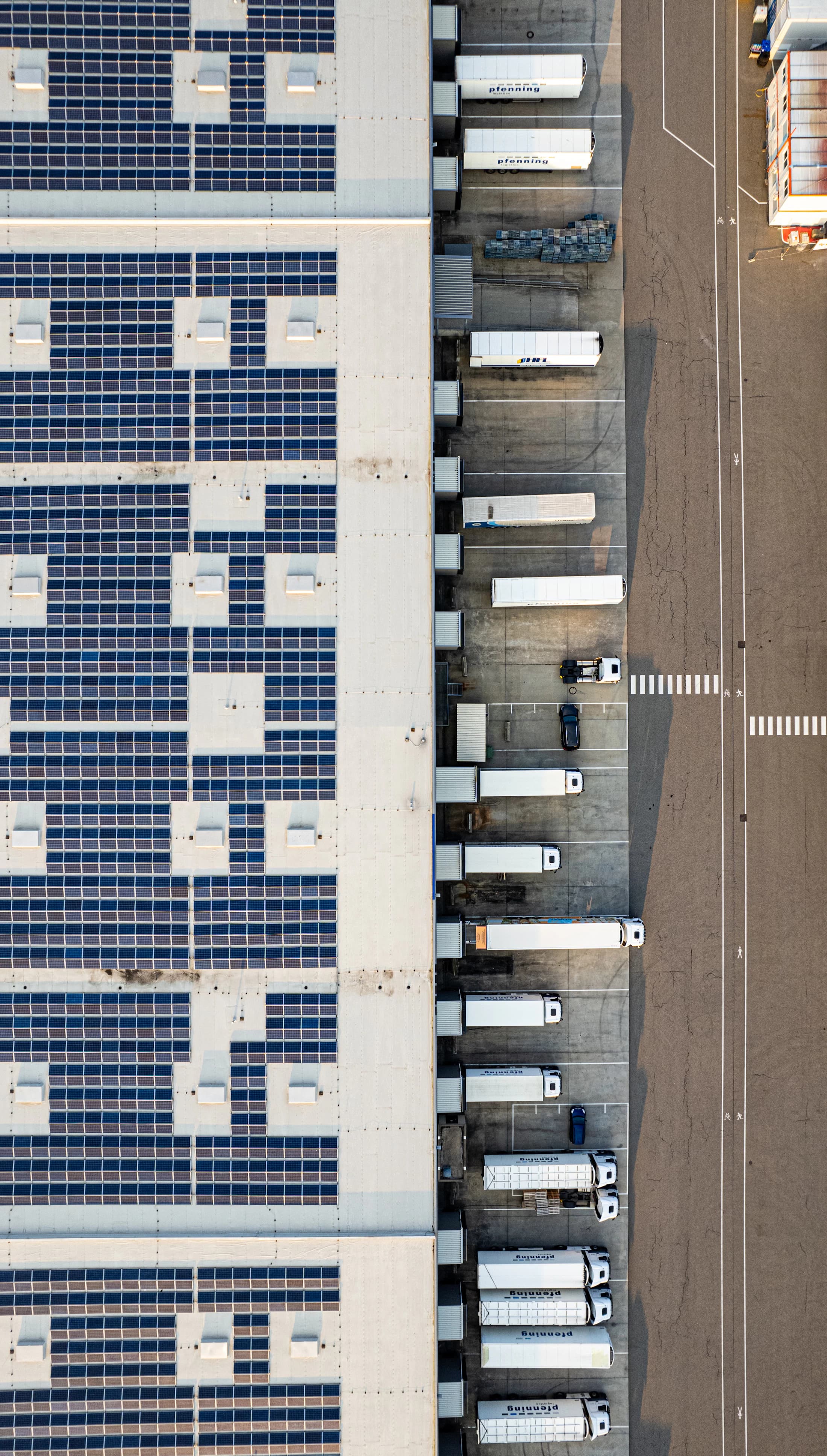 Aerial view of a logistics warehouse with rooftop solar panels